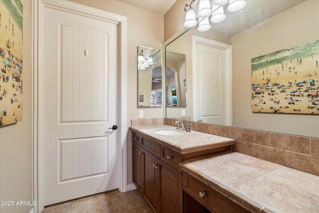 bathroom featuring tile patterned floors, vanity, and an inviting chandelier