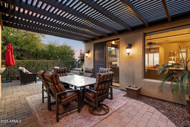 patio terrace at dusk featuring a pergola