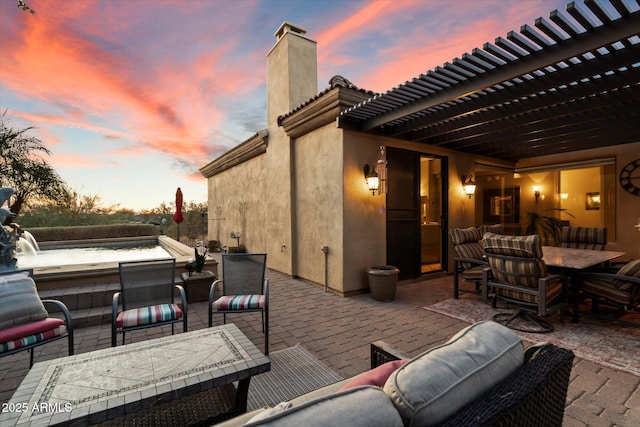 patio terrace at dusk with a pergola