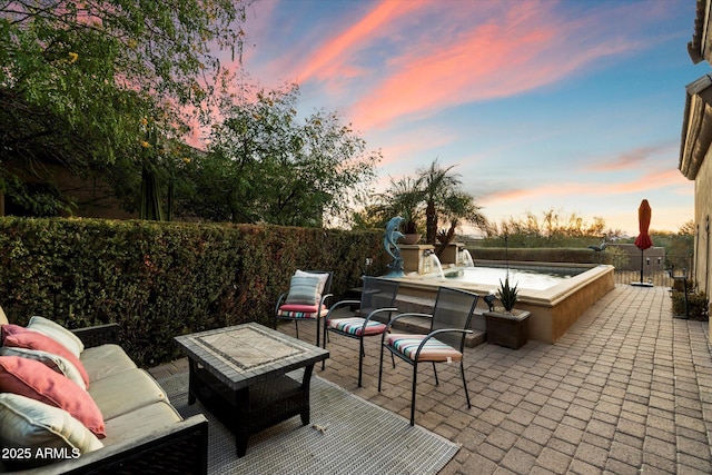 view of patio terrace at dusk