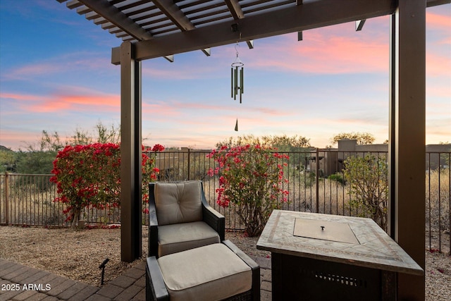 patio terrace at dusk featuring a pergola