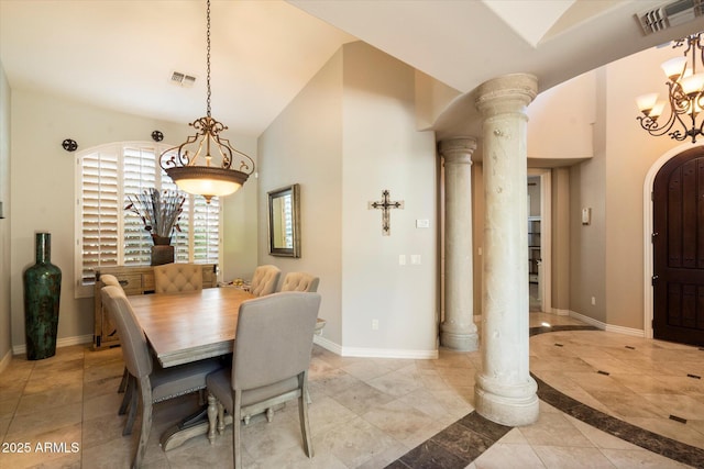 dining area with decorative columns and an inviting chandelier