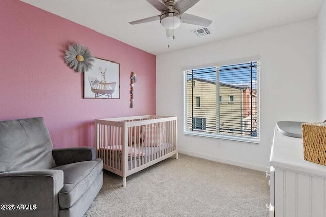 2150 W Alameda Rd Unit 1313, Phoenix, AZ 85085 - carpeted bedroom featuring a crib, baseboards, and a ceiling fan