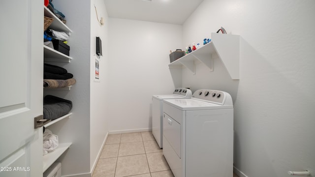 washroom featuring separate washer and dryer and light tile patterned floors