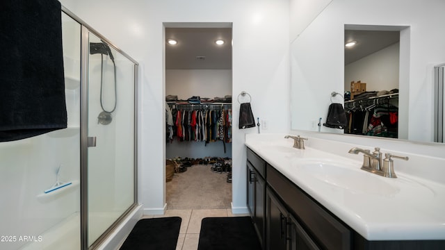 bathroom featuring tile patterned flooring, vanity, and an enclosed shower