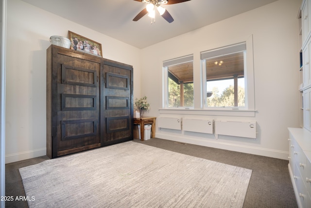 entrance foyer with carpet floors, ceiling fan, and baseboards