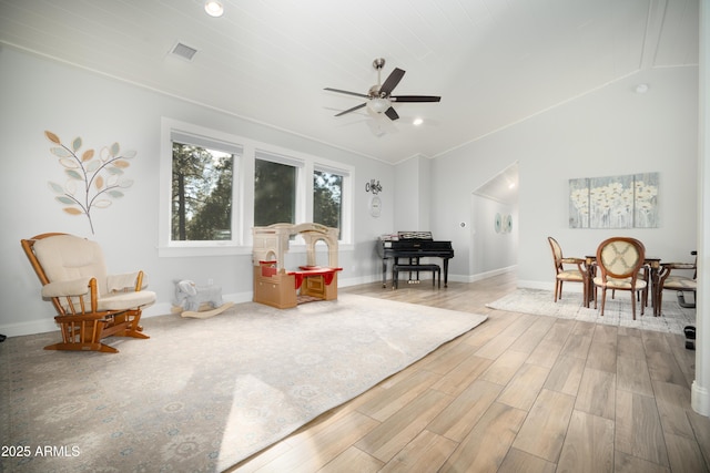 sitting room with lofted ceiling, visible vents, a ceiling fan, wood finished floors, and baseboards