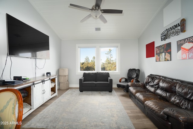 living room featuring dark wood-style floors, visible vents, a ceiling fan, vaulted ceiling, and baseboards