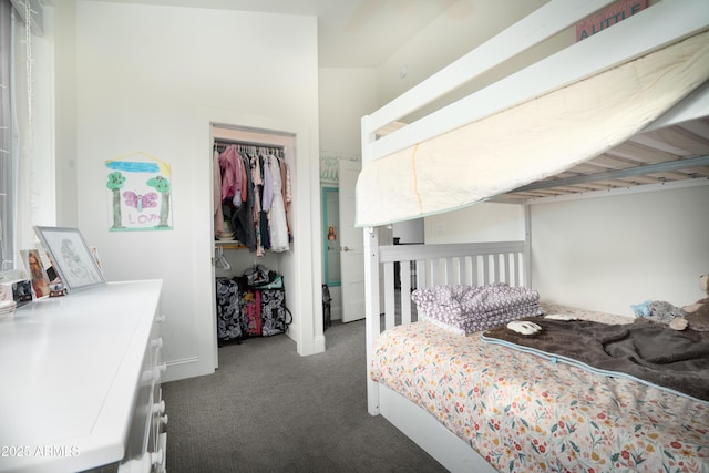 bedroom featuring dark carpet and a closet