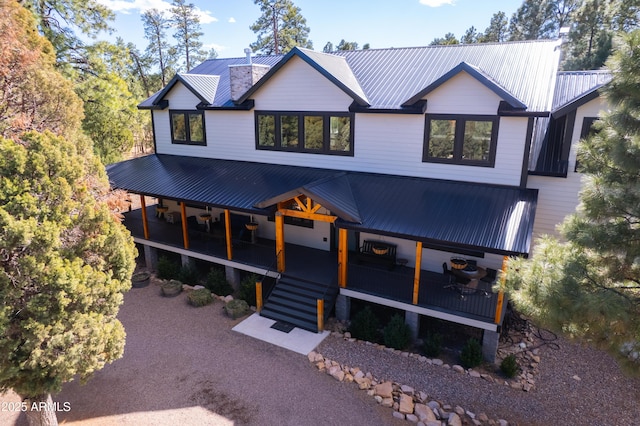 view of front facade featuring metal roof and stairway