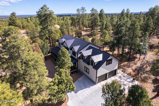 bird's eye view with a wooded view