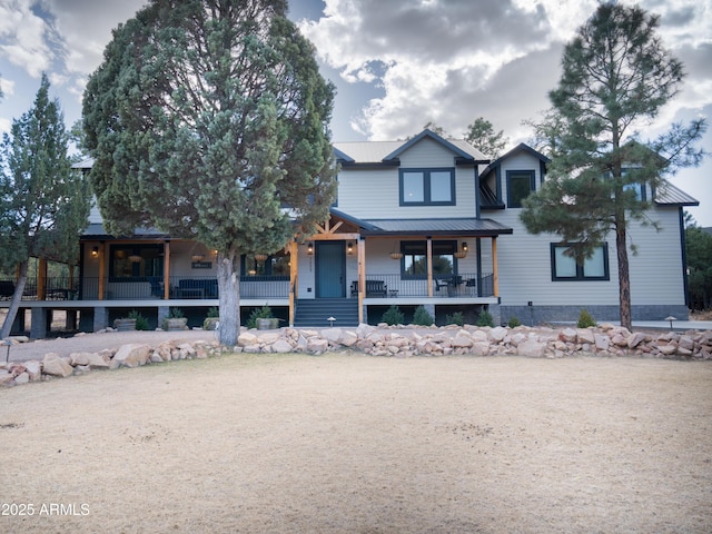 view of front facade featuring a porch and metal roof