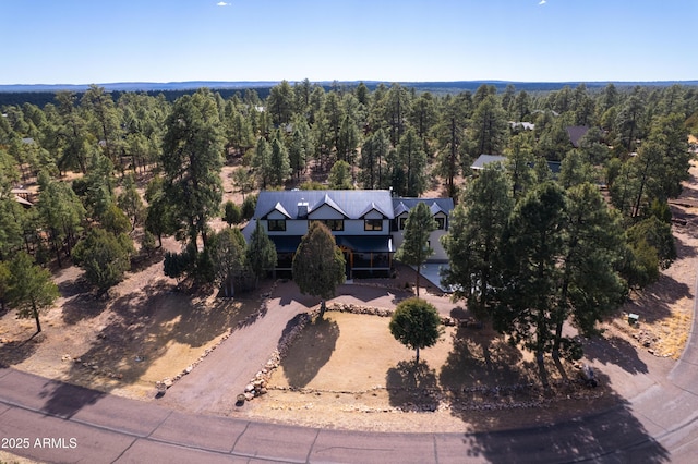 drone / aerial view featuring a view of trees