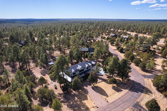 birds eye view of property featuring a forest view