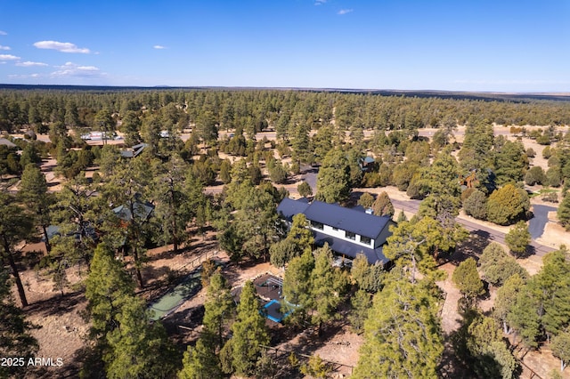 drone / aerial view featuring a view of trees