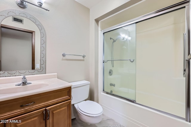 full bathroom with visible vents, shower / bath combination with glass door, vanity, and toilet