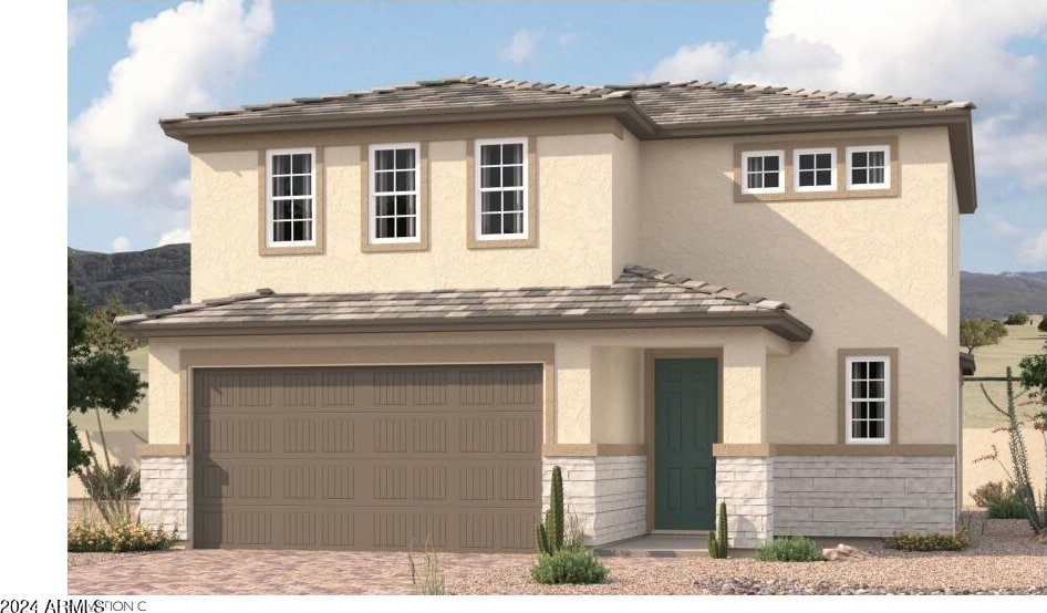 view of front of home with a mountain view and a garage