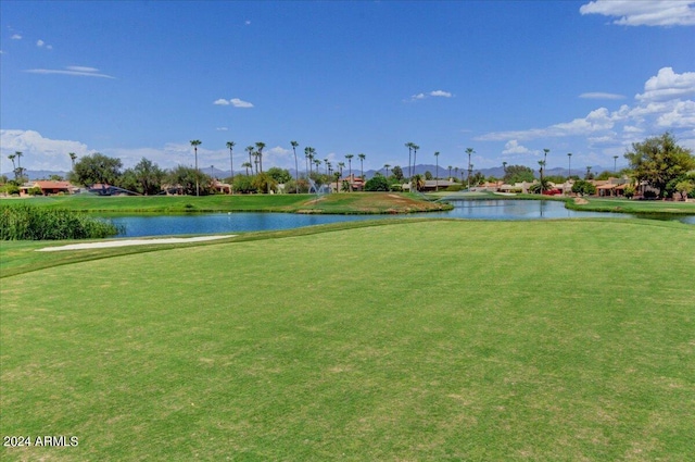 view of community with a yard and a water view