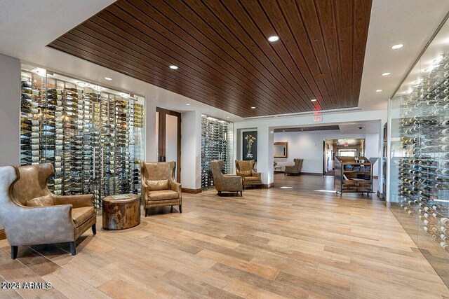 wine cellar with light hardwood / wood-style floors and wood ceiling