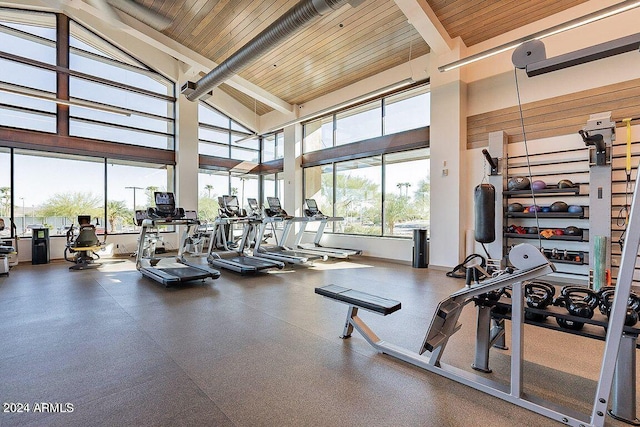 workout area with high vaulted ceiling and wooden ceiling