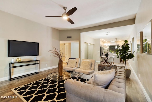 2110 W Navarro Ave, Mesa, AZ 85202 - living area featuring wood finished floors, a ceiling fan, and a chandelier
