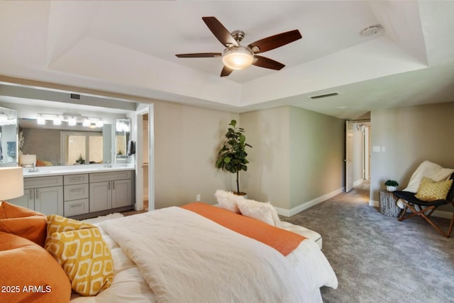 2110 W Navarro Ave, Mesa, AZ 85202 - carpeted bedroom with a tray ceiling, connected bathroom, and ceiling fan