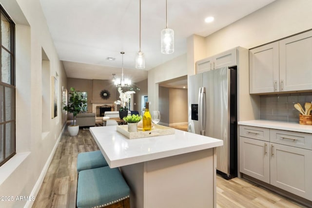 2110 W Navarro Ave, Mesa, AZ 85202 - kitchen with stainless steel fridge with ice dispenser, gray cabinets, light wood finished floors, a center island, and recessed lighting