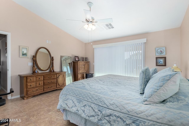 bedroom featuring ceiling fan, light tile patterned floors, and vaulted ceiling