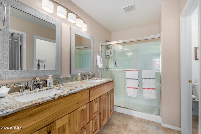 bathroom featuring vanity and a shower with shower door