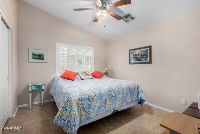 bedroom with vaulted ceiling, a closet, and ceiling fan