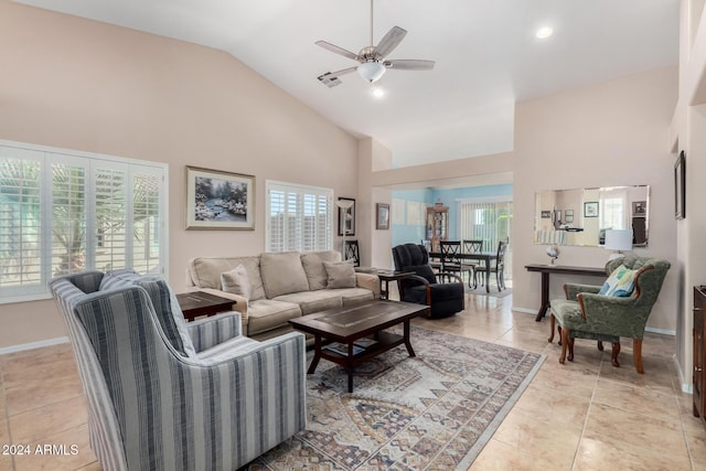 tiled living room featuring high vaulted ceiling, plenty of natural light, and ceiling fan