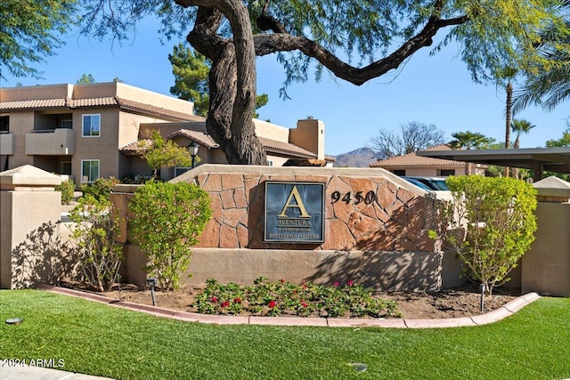 community / neighborhood sign with a lawn