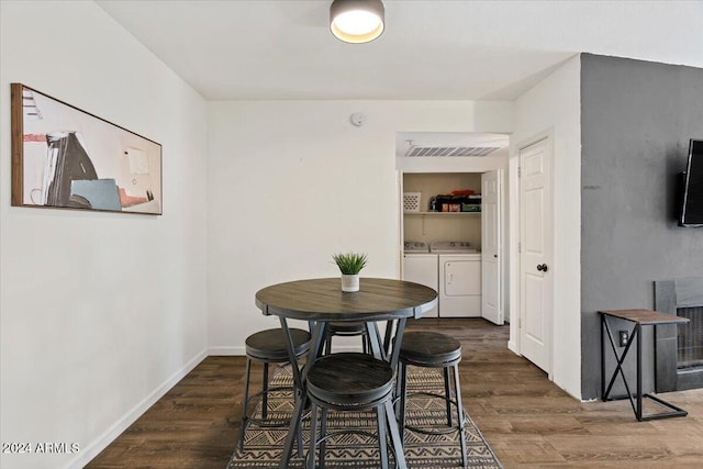 dining room featuring dark hardwood / wood-style flooring and separate washer and dryer