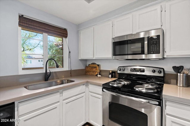 kitchen with white cabinets, sink, and appliances with stainless steel finishes