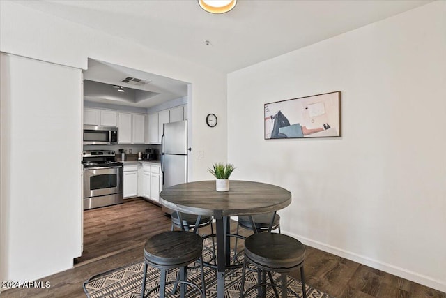 dining area featuring dark wood-type flooring