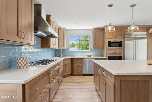 14802 N 3rd Ave, Phoenix, AZ 85023 - kitchen with wall chimney range hood, hanging light fixtures, tasteful backsplash, light wood-type flooring, and stainless steel appliances