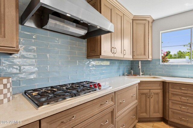 14802 N 3rd Ave, Phoenix, AZ 85023 - kitchen with backsplash, stainless steel gas cooktop, a sink, light countertops, and under cabinet range hood