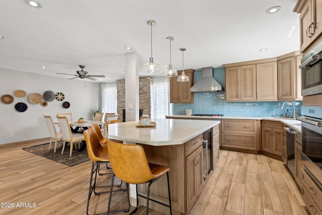 14802 N 3rd Ave, Phoenix, AZ 85023 - kitchen featuring a center island, wall chimney exhaust hood, a sink, light wood finished floors, and backsplash