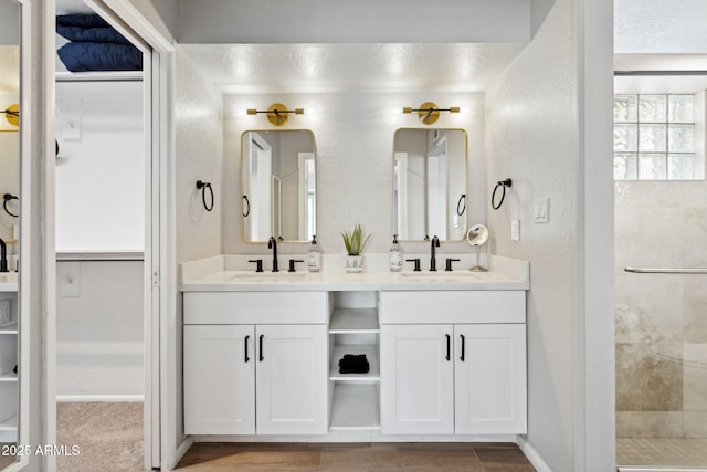 14802 N 3rd Ave, Phoenix, AZ 85023 - bathroom with double vanity, a sink, a textured wall, and a spacious closet