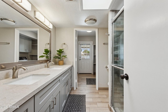 14802 N 3rd Ave, Phoenix, AZ 85023 - bathroom with double vanity, a sink, a stall shower, and wood finished floors