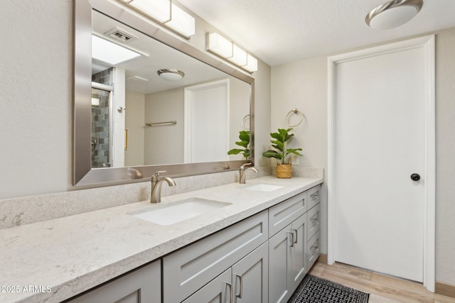 14802 N 3rd Ave, Phoenix, AZ 85023 - full bathroom featuring double vanity, visible vents, a sink, and wood finished floors