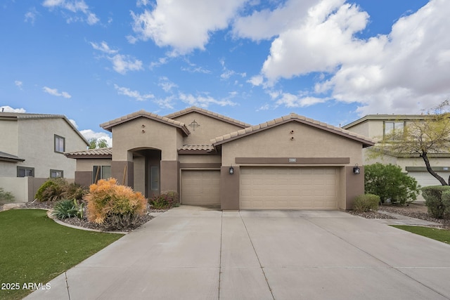 mediterranean / spanish-style home featuring a front lawn, a tile roof, stucco siding, a garage, and driveway