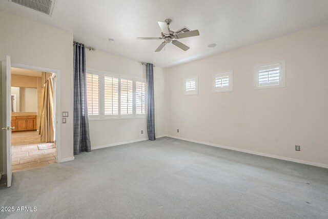 unfurnished bedroom featuring a ceiling fan, carpet flooring, baseboards, and visible vents