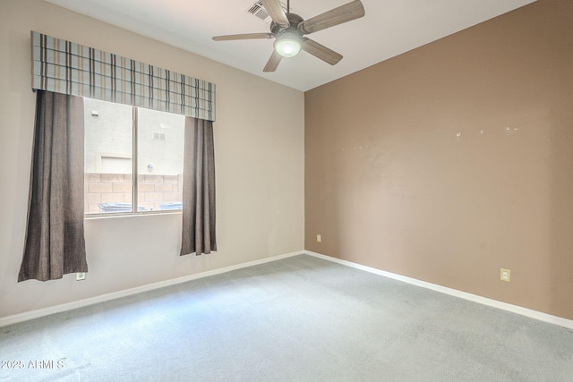 empty room featuring visible vents, baseboards, a ceiling fan, and carpet flooring