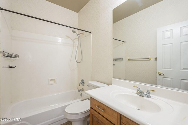 bathroom with vanity, toilet, and bathing tub / shower combination