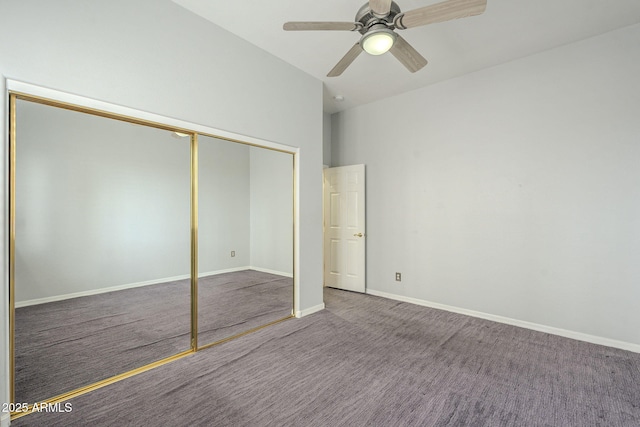 unfurnished bedroom with a closet, carpet flooring, a ceiling fan, and baseboards