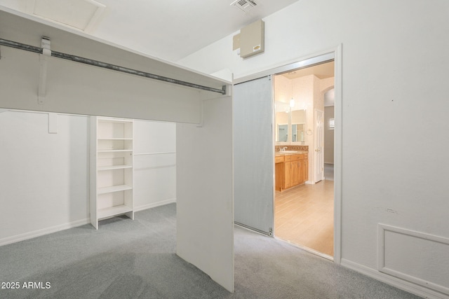 walk in closet with visible vents and carpet