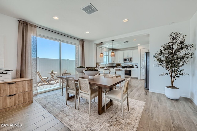 dining room with recessed lighting, light wood-style floors, visible vents, and baseboards