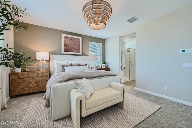 bedroom featuring visible vents, baseboards, light colored carpet, and ensuite bathroom