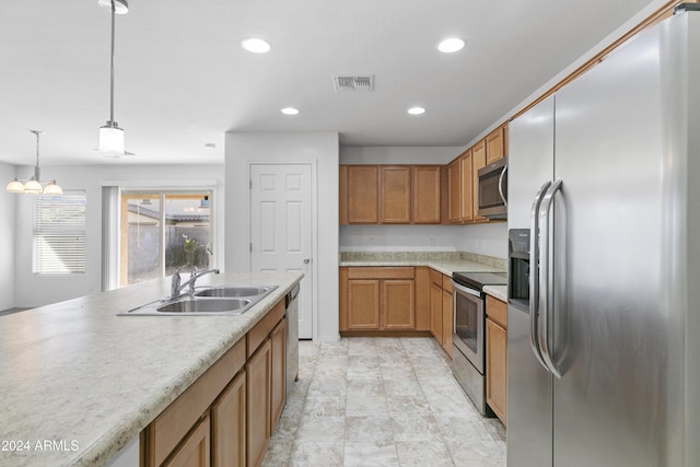 kitchen with a chandelier, decorative light fixtures, stainless steel appliances, and sink